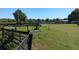 Lush green pasture with mature trees and wooden fencing, creating a tranquil environment for horses and livestock at 2630 Nw 140Th St, Citra, FL 32113