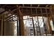 Unfinished home interior displaying exposed wooden framing, revealing the structural elements of the construction at 2630 Nw 140Th St, Citra, FL 32113