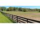 Expansive land features mature trees and a classic black four-board fence at 2630 Nw 140Th St, Citra, FL 32113