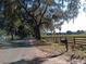 Roadside view of property with fencing, a mailbox and distant equestrian paddock at 2630 Nw 140Th St, Citra, FL 32113