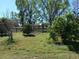 Lush green yard features established trees and wooden fencing at 2630 Nw 140Th St, Citra, FL 32113