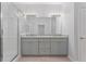 Modern bathroom featuring a double vanity with granite countertops and a glass shower at 288 N Oak Ave, Sanford, FL 32771