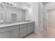 Bathroom with double vanity, granite countertop, modern lighting, and wood-look floors at 288 N Oak Ave, Sanford, FL 32771