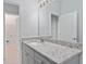 Bathroom vanity features granite countertops and a large mirror with accent lighting at 288 N Oak Ave, Sanford, FL 32771