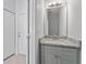 Powder room with gray vanity featuring modern fixtures and granite countertop at 288 N Oak Ave, Sanford, FL 32771