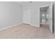 Bedroom with closet, light wood-look floors, and a door to hall at 288 N Oak Ave, Sanford, FL 32771