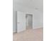 Bright bedroom with light wood floors and a doorway leading to another room at 288 N Oak Ave, Sanford, FL 32771