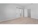 Bright primary bedroom with wood floors and a sliding barn door to the bath at 288 N Oak Ave, Sanford, FL 32771
