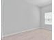 Bedroom with a large window, light wood-look flooring, and neutral walls at 288 N Oak Ave, Sanford, FL 32771