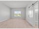 Bedroom with wood floors, natural light, and sliding barn door to the bath at 288 N Oak Ave, Sanford, FL 32771
