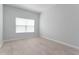 Bright bedroom with light wood-look floors, a large window, and neutral walls at 288 N Oak Ave, Sanford, FL 32771