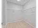 Walk-in closet with wire shelving, light wood-look flooring, and white trim at 288 N Oak Ave, Sanford, FL 32771