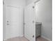 Hallway with wood floors, a door to the garage, and a powder room with granite countertop at 288 N Oak Ave, Sanford, FL 32771
