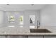 Bright kitchen view featuring granite countertops, a stainless steel sink, and ample natural light at 288 N Oak Ave, Sanford, FL 32771