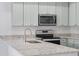 Gourmet kitchen with modern stainless steel appliances and granite countertops at 288 N Oak Ave, Sanford, FL 32771