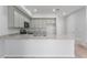 Modern kitchen with stainless steel appliances, gray cabinets, and granite countertops at 288 N Oak Ave, Sanford, FL 32771