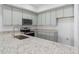 Modern kitchen featuring stainless steel appliances, granite countertops, and stylish gray cabinetry at 288 N Oak Ave, Sanford, FL 32771