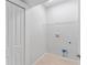 Bright laundry room with a door, utility connections, and ample space for cleaning at 288 N Oak Ave, Sanford, FL 32771