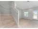 Bright living room featuring wood floors, recessed lighting, and an open staircase at 288 N Oak Ave, Sanford, FL 32771