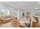 Bright living room featuring neutral decor, comfortable seating, and ample natural light throughout the living space at 288 N Oak Ave, Sanford, FL 32771