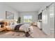 Serene main bedroom with wood-look floors, natural light, and stylish modern decor at 288 N Oak Ave, Sanford, FL 32771