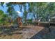 Spacious backyard featuring a wooden deck with outdoor seating and a wooden playset for enjoyment at 2940 N Huron Dr, Deltona, FL 32738