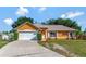 Charming single-story home with a well-manicured lawn, inviting entrance and two car garage at 2940 N Huron Dr, Deltona, FL 32738