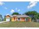 Charming single-story home with a well-manicured lawn, inviting entrance and two car garage at 2940 N Huron Dr, Deltona, FL 32738