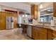 Kitchen features stainless steel appliances, wooden cabinets, granite countertops, and a breakfast bar with seating at 2940 N Huron Dr, Deltona, FL 32738
