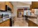 Kitchen with stainless steel appliances, wooden cabinets, granite countertops, and tile flooring at 2940 N Huron Dr, Deltona, FL 32738