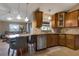 Kitchen with granite countertops, wooden cabinets, stainless steel appliances, and bar stool seating at 2940 N Huron Dr, Deltona, FL 32738