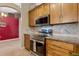 Kitchen with stainless steel appliances, granite countertops, wooden cabinets, and tile flooring at 2940 N Huron Dr, Deltona, FL 32738