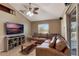 Comfortable living room with a large sectional, and a sliding glass door to the outdoor deck at 2940 N Huron Dr, Deltona, FL 32738