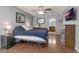 Main bedroom with light blue walls, ceiling fan, wood floors, and en-suite bathroom entrance at 2940 N Huron Dr, Deltona, FL 32738