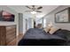 Bedroom featuring a ceiling fan, television, wood floors, neutral wall paint, and slider to balcony at 2940 N Huron Dr, Deltona, FL 32738