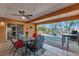 Covered patio area with an outdoor dining table and chairs, offering serene views of the backyard at 2940 N Huron Dr, Deltona, FL 32738