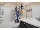 Bright bathroom features a tub and shower combination with a charming, artistic shower curtain at 3970 Sw 51St Ter, Ocala, FL 34474