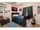 Cozy bedroom with hardwood floors, a comfortable bed, and natural light from the window at 3970 Sw 51St Ter, Ocala, FL 34474