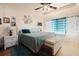 Bedroom features a ceiling fan, natural light, wood floors, and neutral paint at 3970 Sw 51St Ter, Ocala, FL 34474