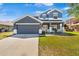 Charming two-story home featuring a well-maintained lawn, two-car garage, and inviting front porch at 3970 Sw 51St Ter, Ocala, FL 34474