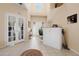 Bright foyer featuring tile flooring, a cabinet for storage, and a view of the home's layout at 3970 Sw 51St Ter, Ocala, FL 34474