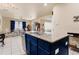 Open kitchen view with blue island, granite counters, stainless appliances, and tile floor at 3970 Sw 51St Ter, Ocala, FL 34474