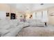 Cozy living room featuring neutral walls, tile floors, and a large sectional sofa, perfect for relaxation at 3970 Sw 51St Ter, Ocala, FL 34474