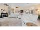 Bright living room featuring a fireplace, sectional sofa, and open layout to the kitchen and entryway at 3970 Sw 51St Ter, Ocala, FL 34474