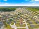 Aerial perspective of a residential area showcasing a community with multiple single-Gathering homes and green spaces at 4881 Se 91St Pl, Ocala, FL 34480