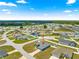 Overhead shot of a residential home nestled in a suburban community with lush greenery and clear blue skies at 4881 Se 91St Pl, Ocala, FL 34480