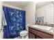 Bathroom featuring vanity with countertop and shower with floral patterned curtain at 4881 Se 91St Pl, Ocala, FL 34480