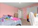 bedroom featuring pink textured walls, carpeted floors, and a closet with storage at 4881 Se 91St Pl, Ocala, FL 34480