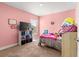 bedroom featuring pink textured walls, carpeted floors, and a window for natural light at 4881 Se 91St Pl, Ocala, FL 34480