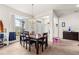 Cozy dining room featuring a wooden table set with seating for six, adjacent to a bright window at 4881 Se 91St Pl, Ocala, FL 34480